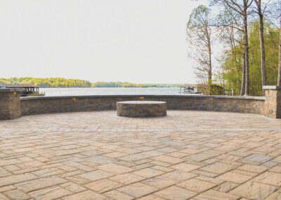 Large patio with fire pit and seat walls with Lake Anna beyond